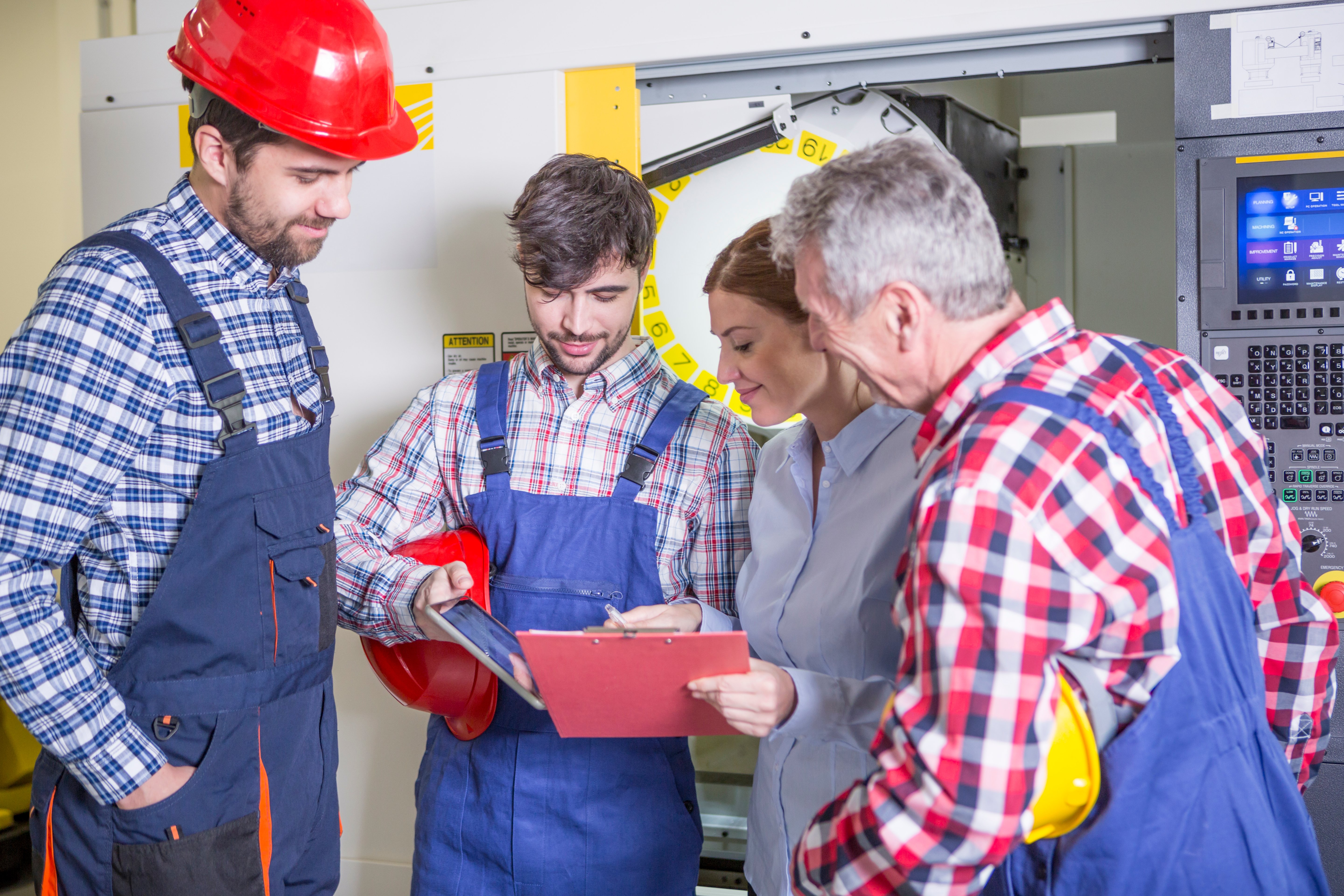 staff-discussing-in-factory-with-cnc-machine-in-ba-2022-12-16-22-39-04-utc